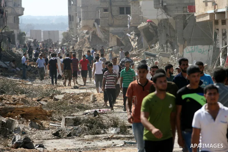 Palestinians walk among the rubble of destroyed houses in the east of Khan Younis, which witnesses said was heavily hit by Israeli shelling and air strikes during an Israeli offensive, in the southern Gaza Strip August 1...