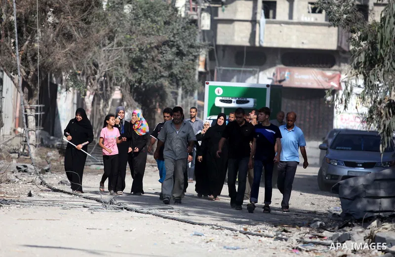 Palestinians who were displaced from their houses due fighting between Israel's army and Hamas fighters return to check their homes in Gaza City's Shejaiya neighbourhood, on August 1, 2014. Israeli shelling killed eight...