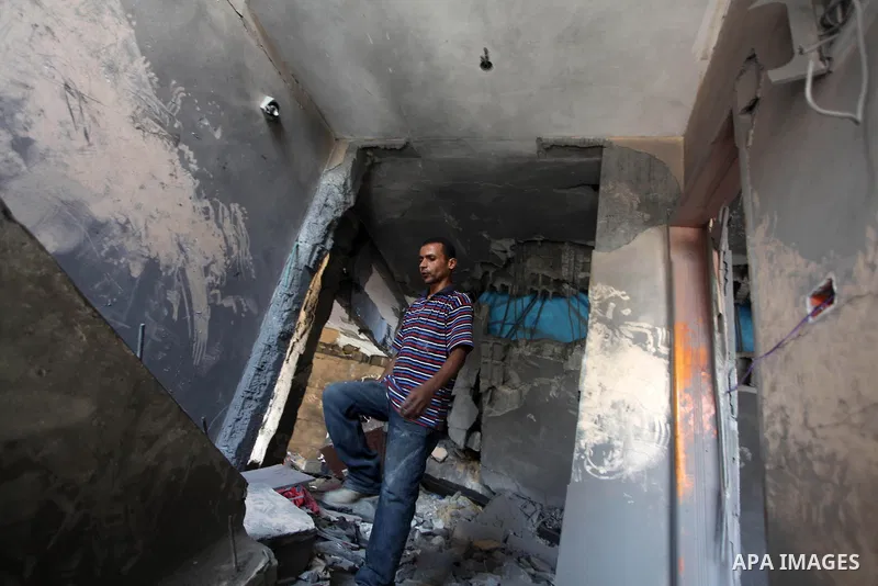 Palestinians inspect the destroyed house, which witnesses said was heavily hit by Israeli air strikes, in Nusseirat in the central Gaza Strip, August 1, 2014. A Gaza ceasefire crumbled only hours after it began on Friday...