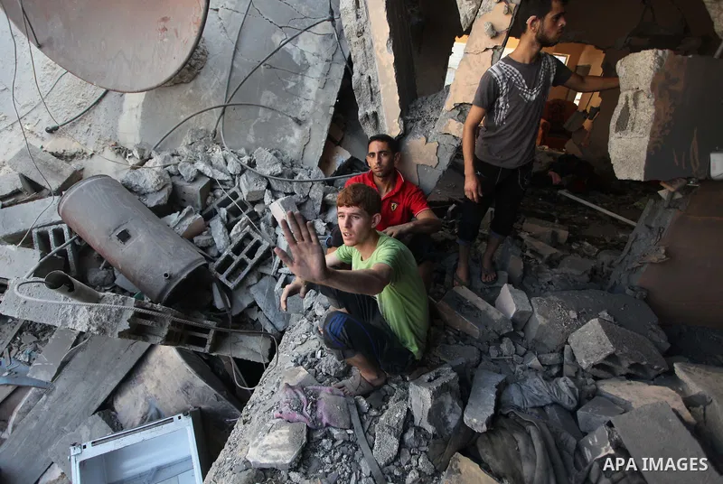 Palestinians inspect the destroyed house, which witnesses said was heavily hit by Israeli air strikes, in Nusseirat in the central Gaza Strip, August 1, 2014. A Gaza ceasefire crumbled only hours after it began on Friday...