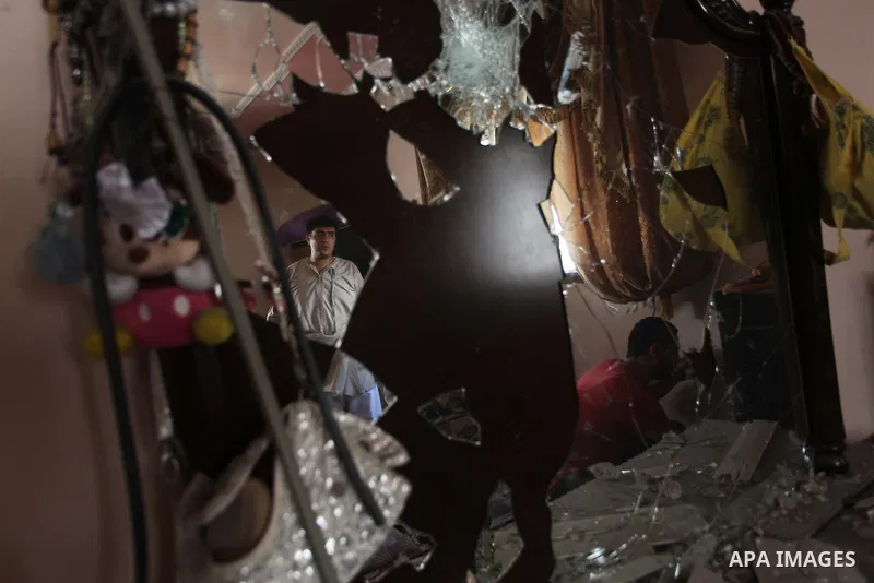 Palestinians inspect the destroyed house, which witnesses said was heavily hit by Israeli air strikes, in the Bureij refugee camp in the central Gaza Strip on Friday, Aug. 01, 2014. A Gaza ceasefire crumbled only hours a...