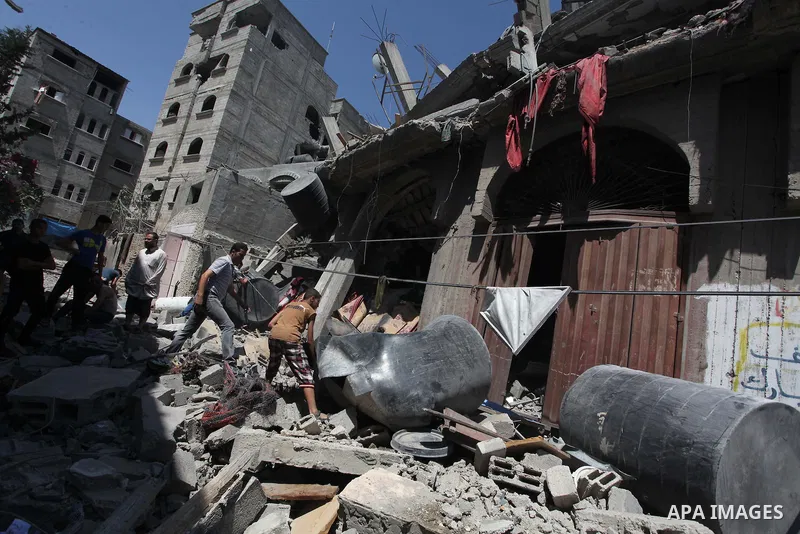 Palestinians inspect the destroyed house, which witnesses said was heavily hit by Israeli air strikes, in the Bureij refugee camp in the central Gaza Strip on Friday, Aug. 01, 2014. A Gaza ceasefire crumbled only hours a...