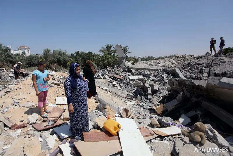 Palestinians inspect the destroyed house, which witnesses said was heavily hit by Israeli air strikes, in the Bureij refugee camp in the central Gaza Strip on Friday, Aug. 01, 2014. A Gaza ceasefire crumbled only hours a...