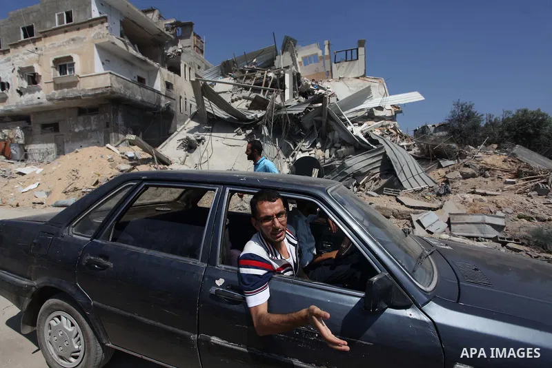 Palestinians inspect the destroyed house, which witnesses said was heavily hit by Israeli air strikes, in the Bureij refugee camp in the central Gaza Strip on Friday, Aug. 01, 2014. A Gaza ceasefire crumbled only hours a...