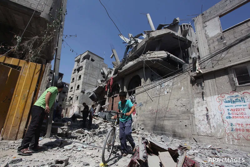 Palestinians inspect the destroyed house, which witnesses said was heavily hit by Israeli air strikes, in the Bureij refugee camp in the central Gaza Strip on Friday, Aug. 01, 2014. A Gaza ceasefire crumbled only hours a...