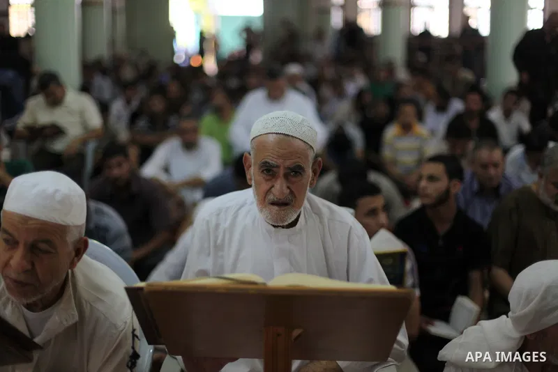 Palestinian relatives mourn for eight members of the Bayoumi family, who were killed in an Israeli air strike on their building, at Al Qassam mosque during their funeral in Nusseirat refugee camp, in the central Gaza Str...