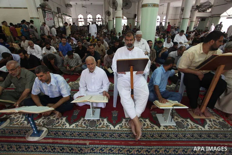 Palestinian relatives mourn for eight members of the Bayoumi family, who were killed in an Israeli air strike on their building, at Al Qassam mosque during their funeral in Nusseirat refugee camp, in the central Gaza Str...
