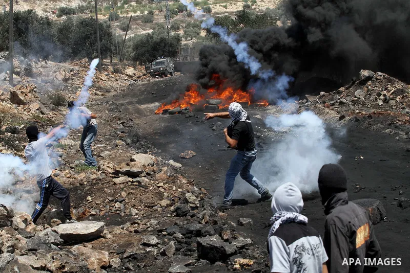 Palestinians protesters hurls rocks at Israeli security forces during clashes following a protest in the village of Kfar Qaddum, near the northern city of Nablus, in the occupied West Bank on August 1, 2014. A joint Pale...