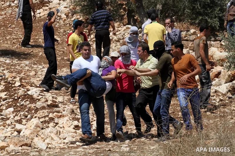 Palestinians protesters hurls rocks at Israeli security forces during clashes following a protest in the village of Kfar Qaddum, near the northern city of Nablus, in the occupied West Bank on August 1, 2014. A joint Pale...