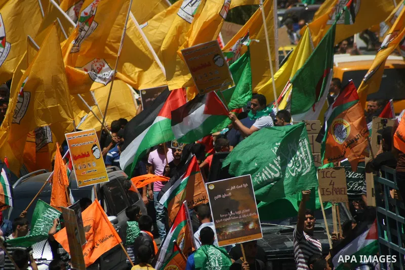 Palestinians hold placards during a demonstration against Israel's military operation in the Gaza Strip and in support of Gaza's people on August 1, 2014 in the West Bank town of Hebron. Some placards ask to refer Israel...