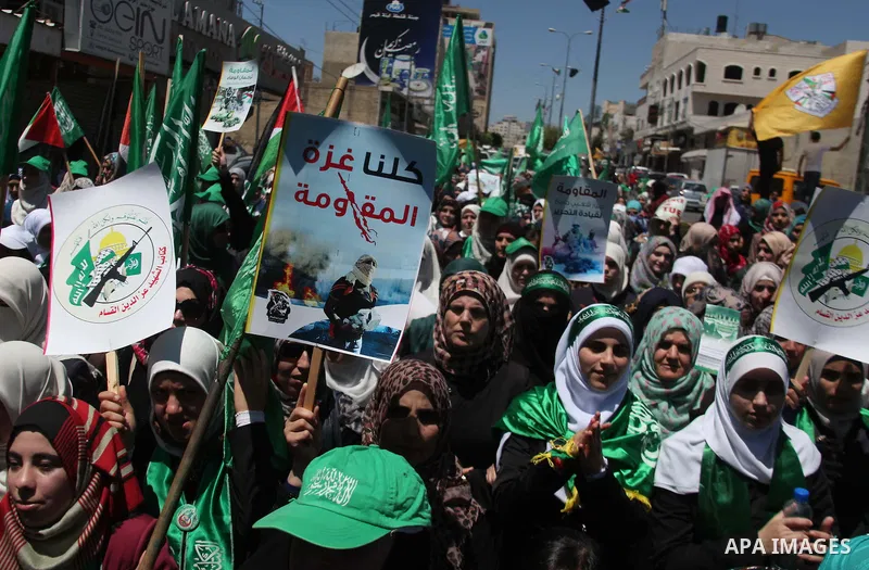 Palestinians hold placards during a demonstration against Israel's military operation in the Gaza Strip and in support of Gaza's people on August 1, 2014 in the West Bank town of Hebron. Some placards ask to refer Israel...