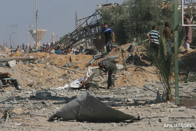 Palestinians walk among the rubble of destroyed houses in the east of Khan Younis, which witnesses said was heavily hit by Israeli shelling and air strikes during an Israeli offensive, in the southern Gaza Strip August 1...