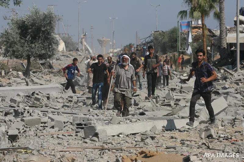 Palestinians walk among the rubble of destroyed houses in the east of Khan Younis, which witnesses said was heavily hit by Israeli shelling and air strikes during an Israeli offensive, in the southern Gaza Strip August 1...