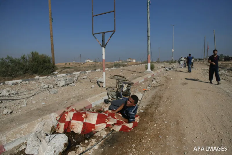Palestinians walk among the rubble of destroyed houses in the east of Khan Younis, which witnesses said was heavily hit by Israeli shelling and air strikes during an Israeli offensive, in the southern Gaza Strip August 1...