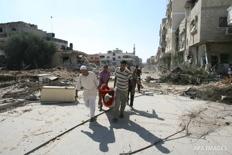 Palestinians walk among the rubble of destroyed houses in the east of Khan Younis, which witnesses said was heavily hit by Israeli shelling and air strikes during an Israeli offensive, in the southern Gaza Strip August 1...