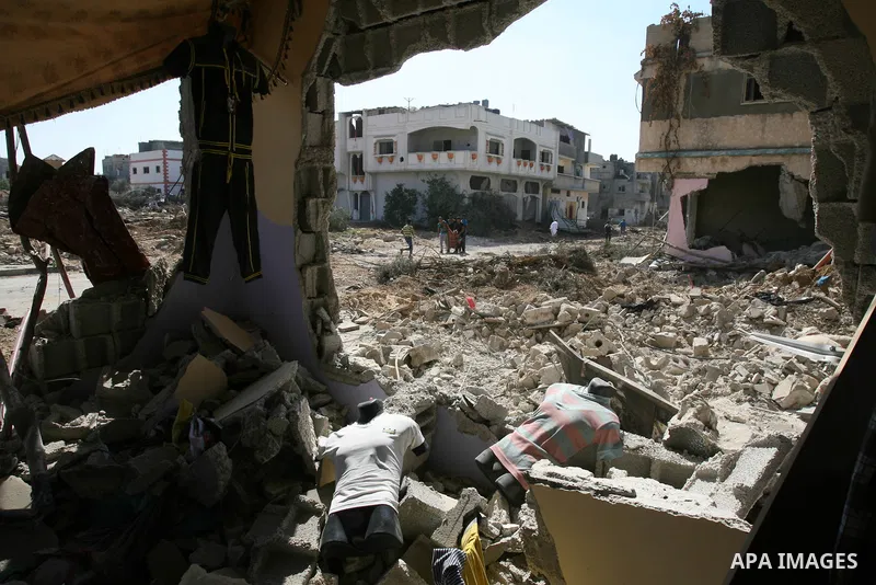 Palestinians walk among the rubble of destroyed houses in the east of Khan Younis, which witnesses said was heavily hit by Israeli shelling and air strikes during an Israeli offensive, in the southern Gaza Strip August 1...
