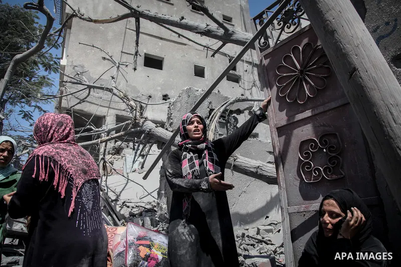 A Palestinian woman stands near the rubble of destroyed houses in the heavily bombed town of Beit Hanoun, Gaza Strip, close to the Israeli border, Friday, Aug. 1, 2014. A three-day Gaza cease-fire that began Friday quick...