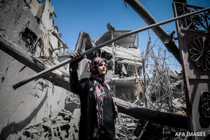 A Palestinian woman stands near the rubble of destroyed houses in the heavily bombed town of Beit Hanoun, Gaza Strip, close to the Israeli border, Friday, Aug. 1, 2014. A three-day Gaza cease-fire that began Friday quick...