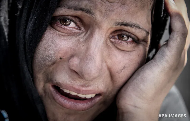 A Palestinian woman stands near the rubble of destroyed houses in the heavily bombed town of Beit Hanoun, Gaza Strip, close to the Israeli border, Friday, Aug. 1, 2014. A three-day Gaza cease-fire that began Friday quick...