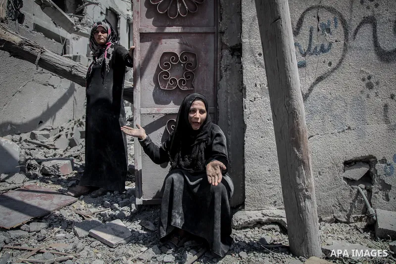 A Palestinian woman stands near the rubble of destroyed houses in the heavily bombed town of Beit Hanoun, Gaza Strip, close to the Israeli border, Friday, Aug. 1, 2014. A three-day Gaza cease-fire that began Friday quick...