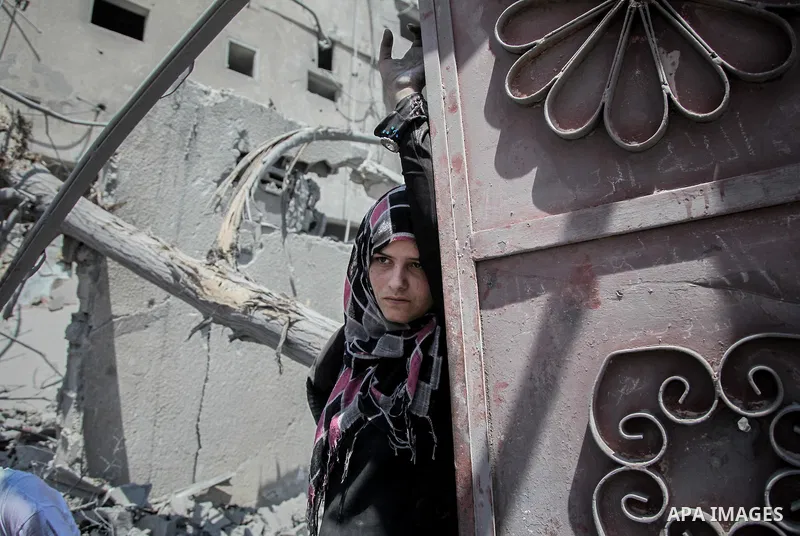 A Palestinian woman stands near the rubble of destroyed houses in the heavily bombed town of Beit Hanoun, Gaza Strip, close to the Israeli border, Friday, Aug. 1, 2014. A three-day Gaza cease-fire that began Friday quick...