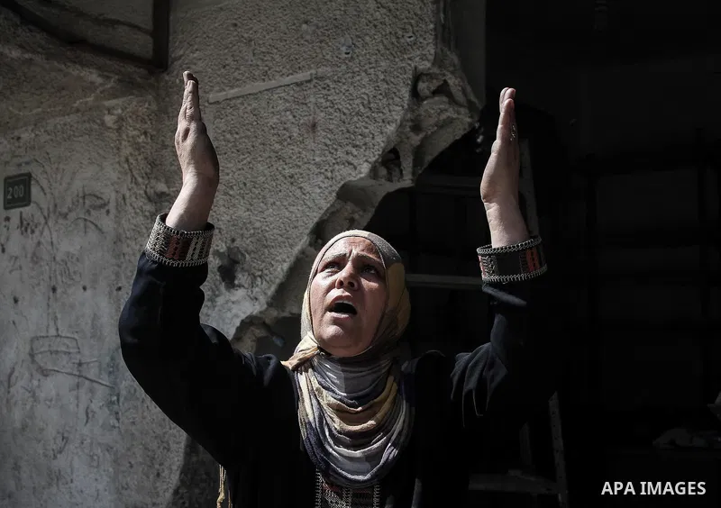 A Palestinian woman stands near the rubble of destroyed houses in the heavily bombed town of Beit Hanoun, Gaza Strip, close to the Israeli border, Friday, Aug. 1, 2014. A three-day Gaza cease-fire that began Friday quick...