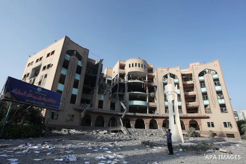 A Palestinian man inspects the damage at the Islamic University of Gaza , on August 2, 2014 in Gaza City after it was hit in an overnight Israeli strike. A fresh wave of violence killed dozens in Gaza after the collapse...