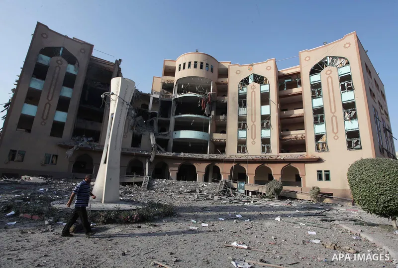 A Palestinian man inspects the damage at the Islamic University of Gaza , on August 2, 2014 in Gaza City after it was hit in an overnight Israeli strike. A fresh wave of violence killed dozens in Gaza after the collapse...