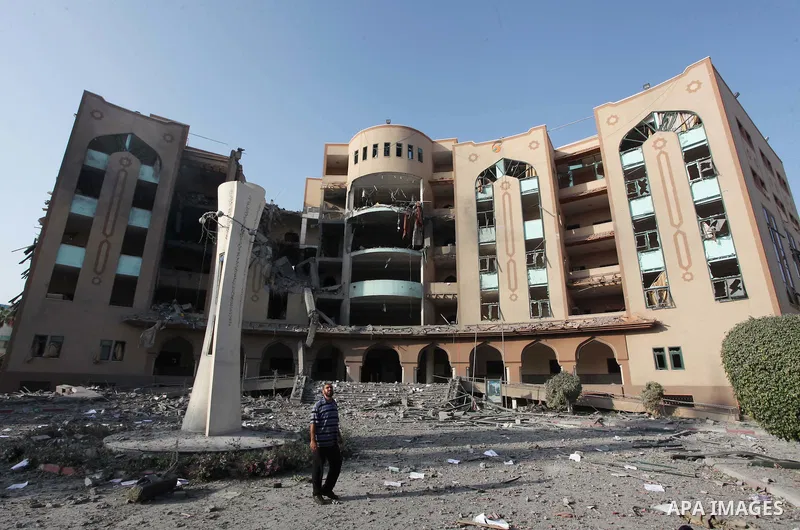 A Palestinian man inspects the damage at the Islamic University of Gaza , on August 2, 2014 in Gaza City after it was hit in an overnight Israeli strike. A fresh wave of violence killed dozens in Gaza after the collapse...