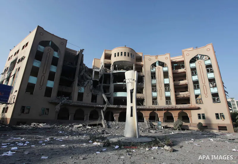 A Palestinian man inspects the damage at the Islamic University of Gaza , on August 2, 2014 in Gaza City after it was hit in an overnight Israeli strike. A fresh wave of violence killed dozens in Gaza after the collapse...