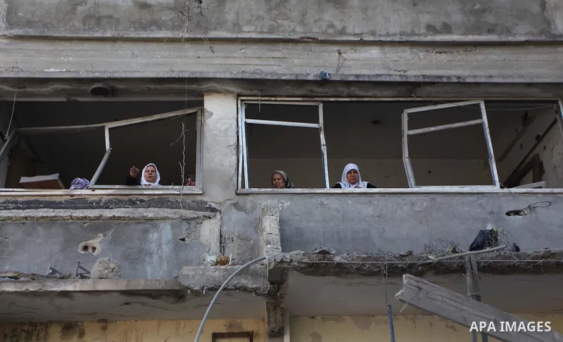 A Palestinian family look out at a destroyed mosque in Gaza City, on August 2, 2014 following an overnight Israeli strike on the Palestinian enclave. A fresh wave of violence killed dozens in Gaza after the collapse of a...