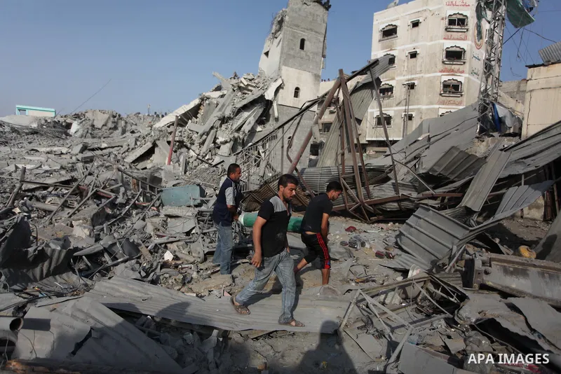 Palestinians inspect the rubble of a destroyed mosque in Gaza City, on August 2, 2014 following an overnight Israeli strike on the Palestinian enclave. A fresh wave of violence killed dozens in Gaza after the collapse of...