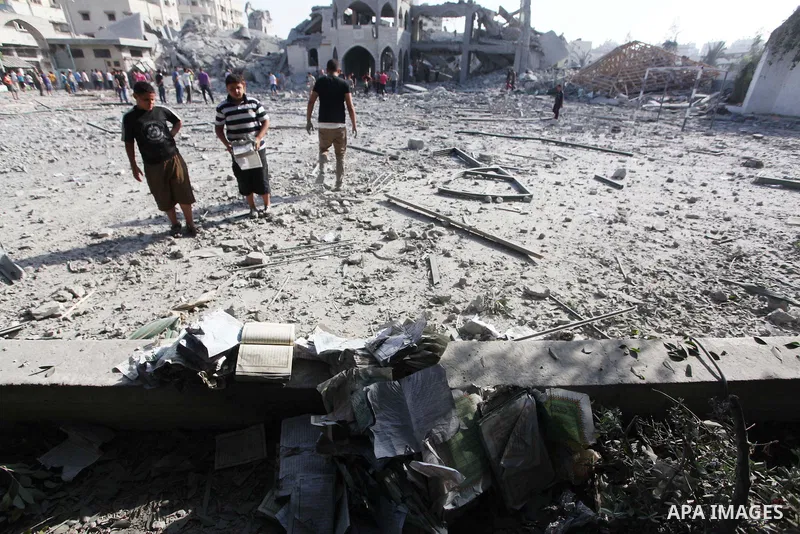 Palestinians inspect the rubble of a destroyed mosque in Gaza City, on August 2, 2014 following an overnight Israeli strike on the Palestinian enclave. A fresh wave of violence killed dozens in Gaza after the collapse of...