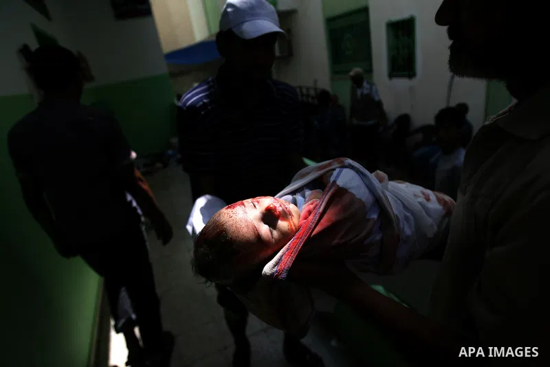 Palestinian relatives carry the body of two month old Noor al-Saidy, killed during attacks on the Gaza Strip, during her funeral in Rafah, in the southern Gaza Strip on August 2, 2014. A fresh wave of violence killed doz...