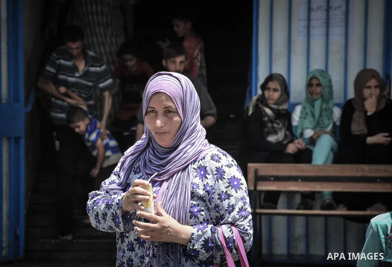 Displaced Palestinians gather at an United Nations (UN) school in Beit Lahia in the northern Gaza Strip, where they and his family found refuge after fleeing their home in an area under heavy Israeli bombardment in the b...