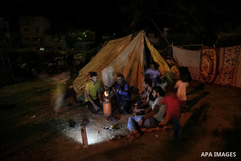 Displaced Palestinians sit outside a makeshift tent on August 2, 2014 at al-Shifa hospital in Gaza City where families found refuge after fleeing their home in an area under heavy Israeli military strikes in the besieged...