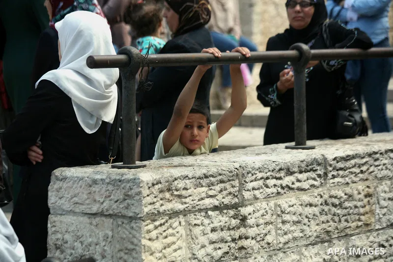 Israeli policemen prevent Palestinian worshippers from entering the Al-Aqsa mosque compound in the Old City of Jerusalem on August 3, 2014. Photo by Saeed Qaq