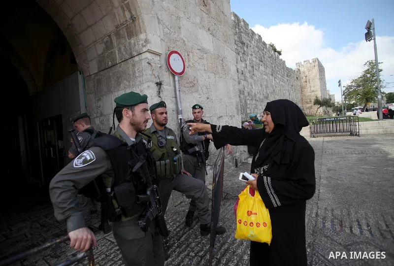 Israeli policemen prevent Palestinian worshippers from entering the Al-Aqsa mosque compound in the Old City of Jerusalem on August 3, 2014. Photo by Saeed Qaq