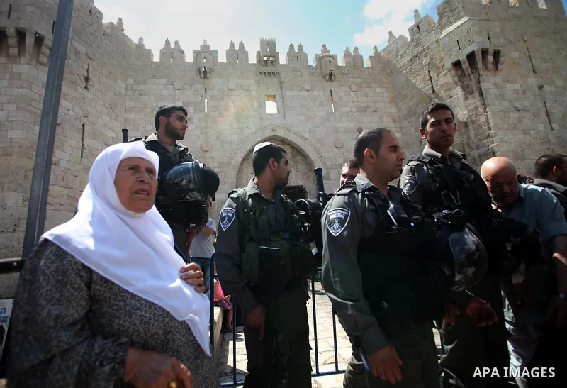 Israeli policemen prevent Palestinian worshippers from entering the Al-Aqsa mosque compound in the Old City of Jerusalem on August 3, 2014. Photo by Saeed Qaq