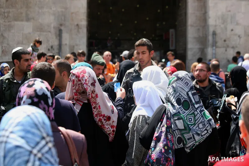 Israeli policemen check documents and belongings of Palestinian worshippers as they preventing them from entering the Al-Aqsa mosque compound in the Old City of Jerusalem on August 3, 2014. Photo by Saeed Qaq