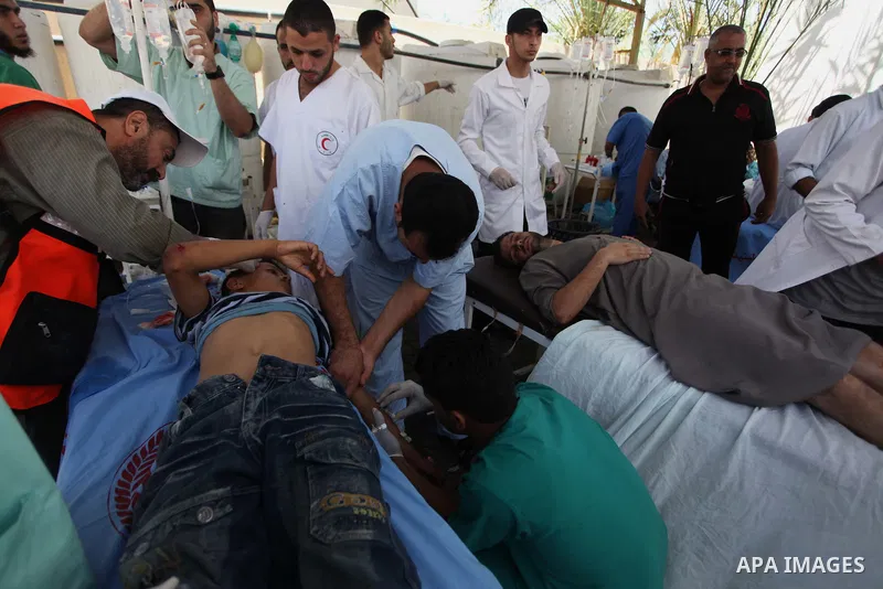 A Palestinian boy, wounded following an Israeli military strike, is treated upon his arrival at the hospital in Rafah in the southern Gaza Strip, on August 3, 2014. At least 10 people were killed in a fresh strike on a U...