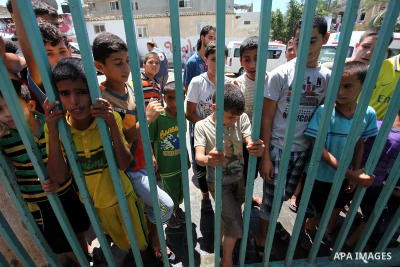 Displaced Palestinian children take shelter at a United Nations run school after Israeli air strikes in Rafah in the southern Gaza Strip on, 03 August 2014. At least 10 people were killed in an airstrike on 03 August 201...