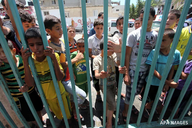 Displaced Palestinian children take shelter at a United Nations run school after Israeli air strikes in Rafah in the southern Gaza Strip on, 03 August 2014. At least 10 people were killed in an airstrike on 03 August 201...
