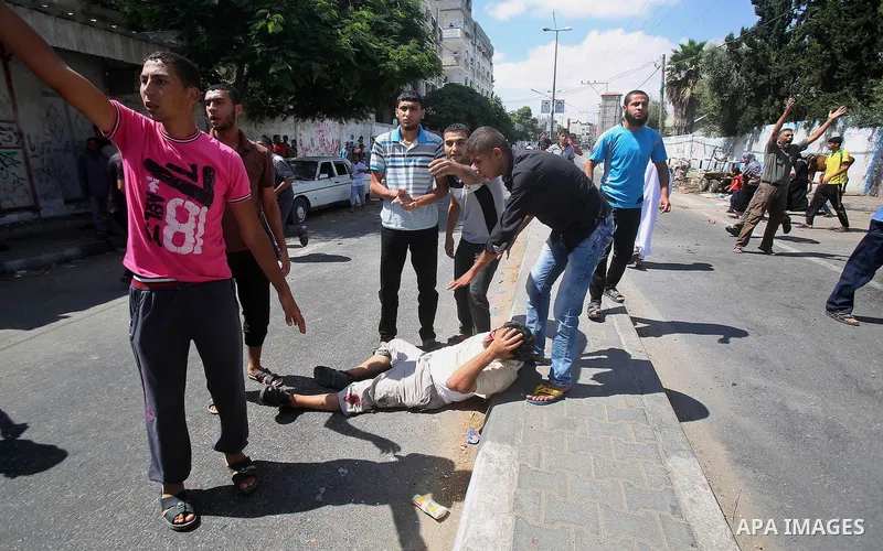 A wounded man at a United Nations run school after Israeli air strikes in Rafah in the southern Gaza Strip on, 03 August 2014. At least 10 people were killed in an airstrike on 03 August 2014 on a United Nations school s...