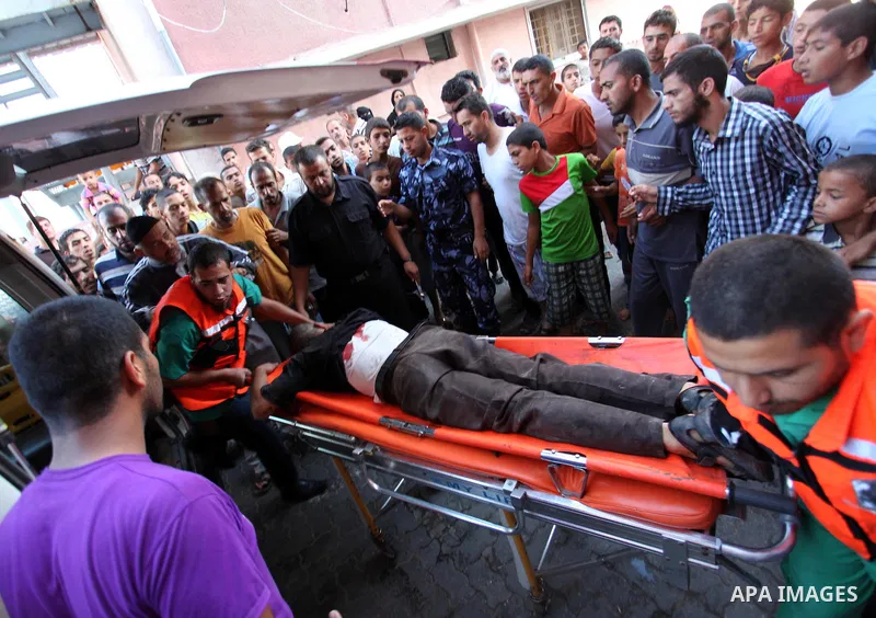 A Palestinian man, wounded following an Israeli military strike, is treated upon his arrival at the hospital in Khan Younis, in the southern Gaza Strip August 3, 2014. An Israeli air strike killed at least 10 people and...