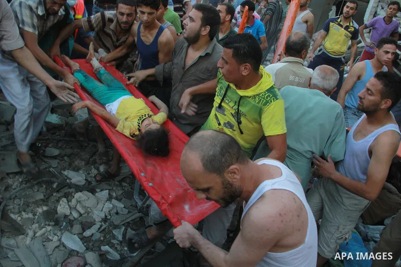 Palestinians evacuate a survivor of an Israeli air strike that hit the Al Ghoul family building in Rafah, southern Gaza Strip, Sunday, Aug. 3, 2014. At least 40 people were inside the Al Ghoul family building in the Rafa...