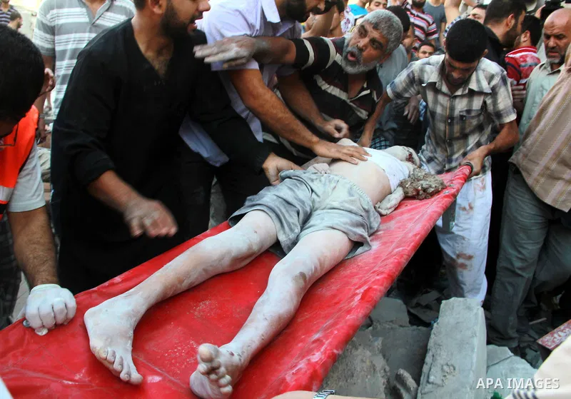 Palestinians evacuate a survivor after an Israeli air strike hit the Al Ghoul family building in Rafah, southern Gaza Strip, Sunday, Aug. 3, 2014. At least 40 people were inside the Al Ghoul family building in Rafah Camp...