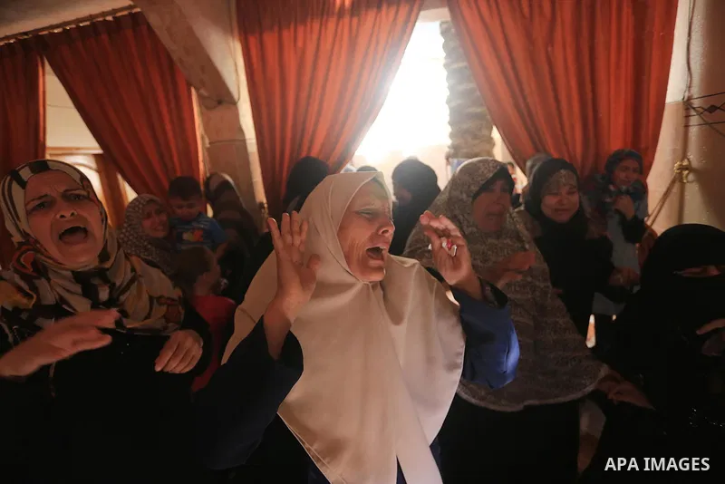 Palestinian relatives mourn on the body of a Palestinian man, Mohammed Shladan, 30, whom medics said was killed in an Israeli air strike on a house, during his funeral in Gaza city August 4, 2014. August 4, 2014. Israel...