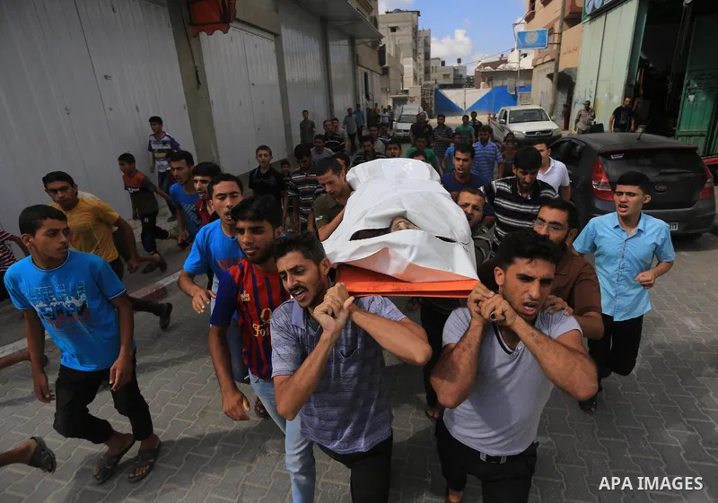 Palestinian relatives carry the body of a Palestinian man, Mohammed Shladan, 30, whom medics said was killed in an Israeli air strike on a house, during his funeral in Gaza city August 4, 2014. August 4, 2014. Israel sai...