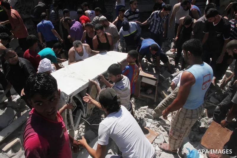 Palestinians dig through the rubble of a building searching for bodies after what police said was an Israeli air strike at Shati (Beach) refugee camp in Gaza City August 4, 2014. A seven-hour truce under which Israel wou...